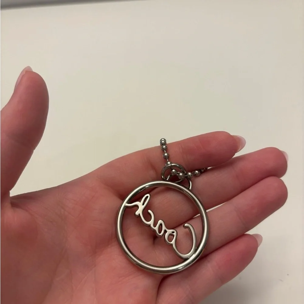 Coach round silver script spellout metal hang tag purse charm chain